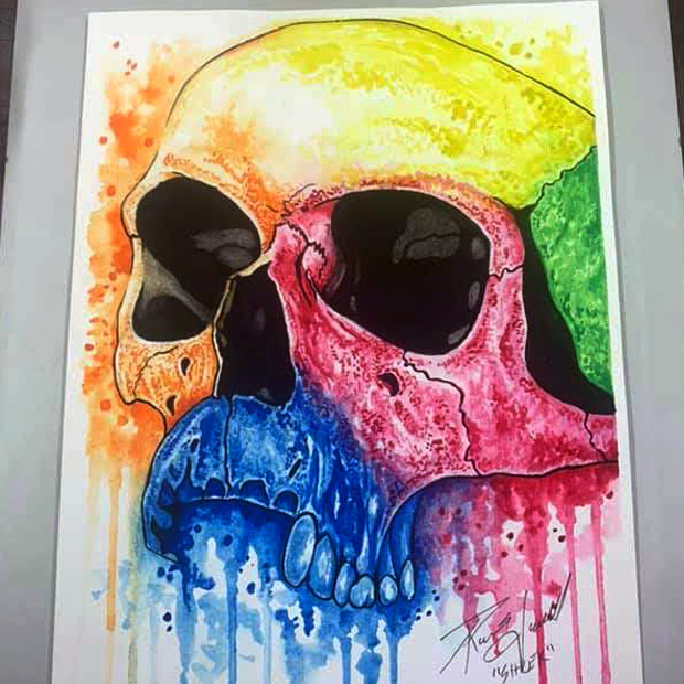illustration of a skull filled in with dripping colors of watercolor paint